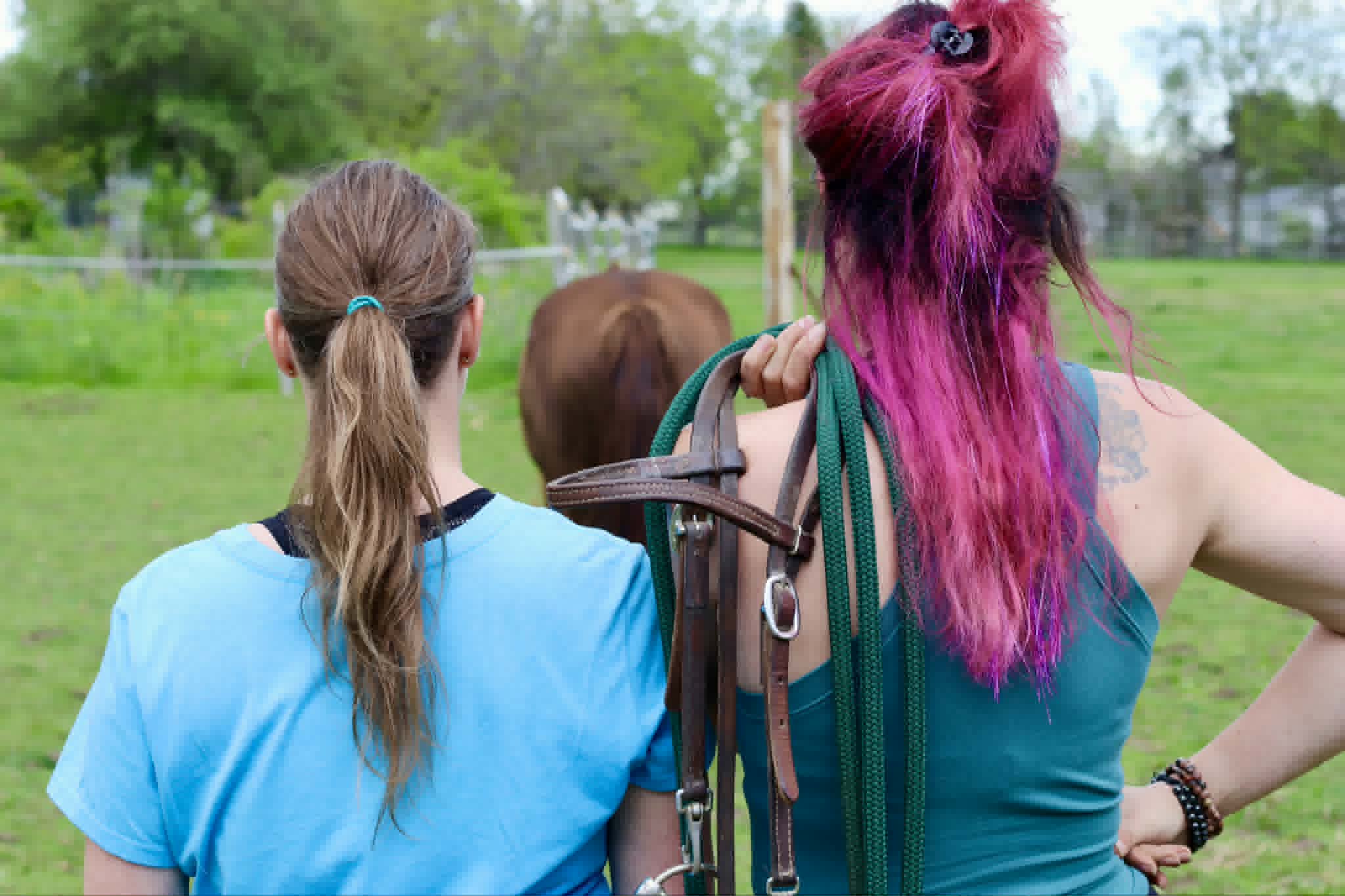 Participants walking alongside a horse during the Unbridled experience